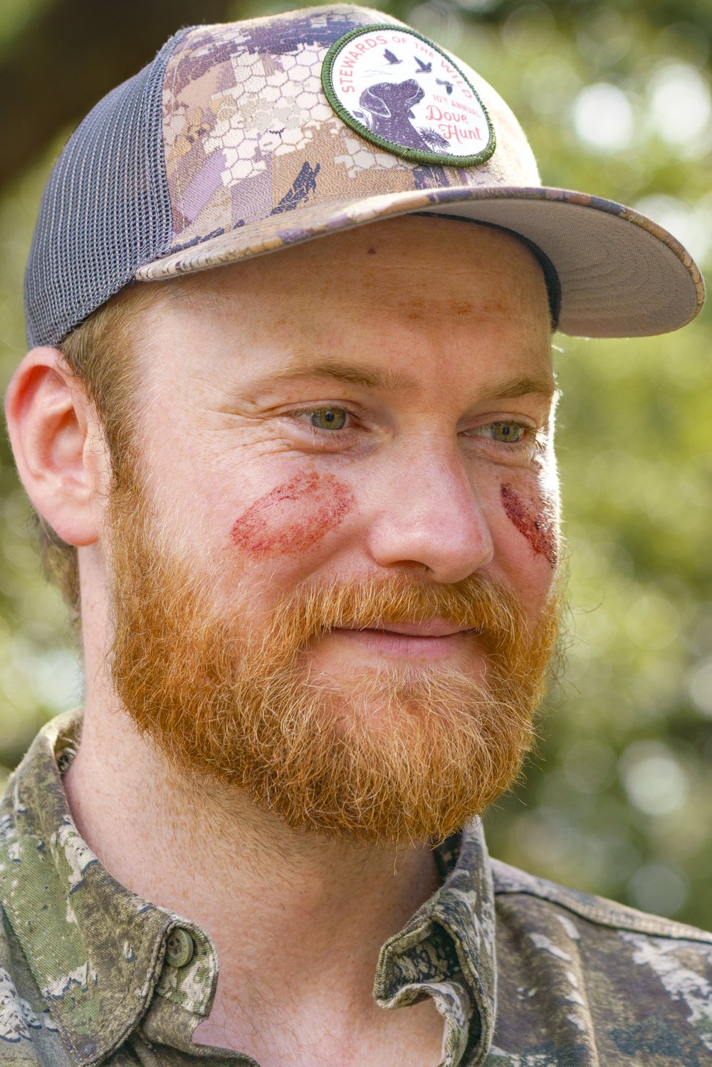 Hunter Eric Robbins' cheeks are marked with blood from his first deer harvest