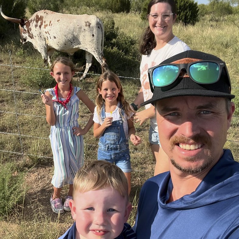 Great Outdoor Scavenger Hunt participants the Tipps family pose with a Longhorn in the background