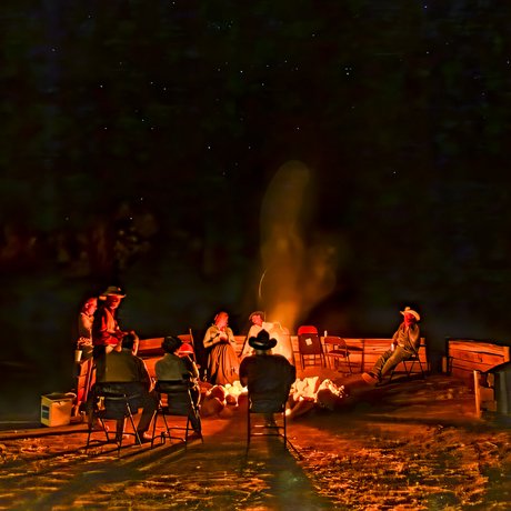 Cowboy poets circle around a campfire to share their poems
