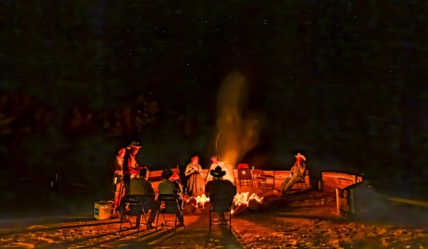 Cowboy poets circle around a campfire to share their poems