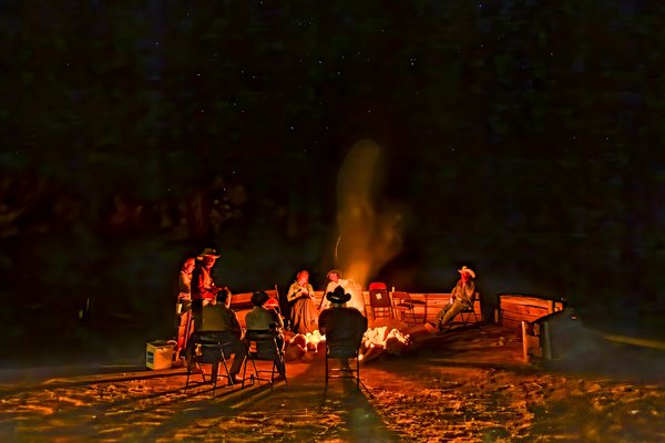 Cowboy poets circle around a campfire to share their poems