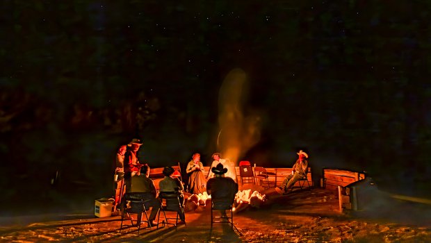 Cowboy poets circle around a campfire to share their poems
