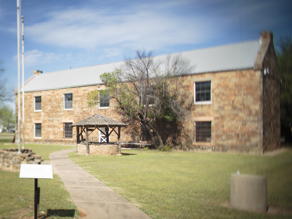 A stone two story building at Fort Belknap.