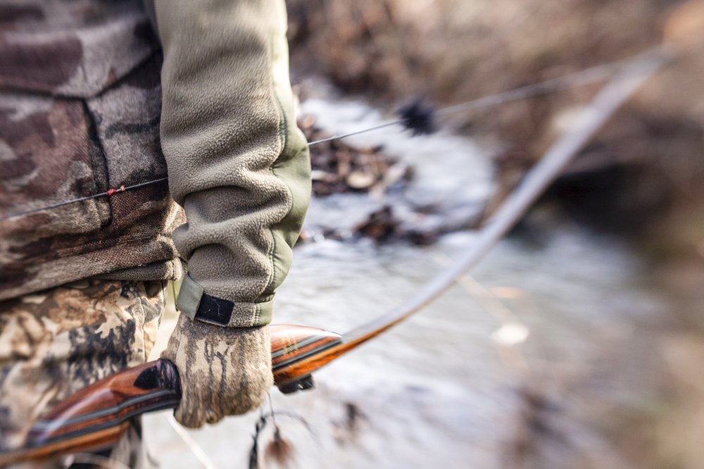 Person holding a traditional bow.
