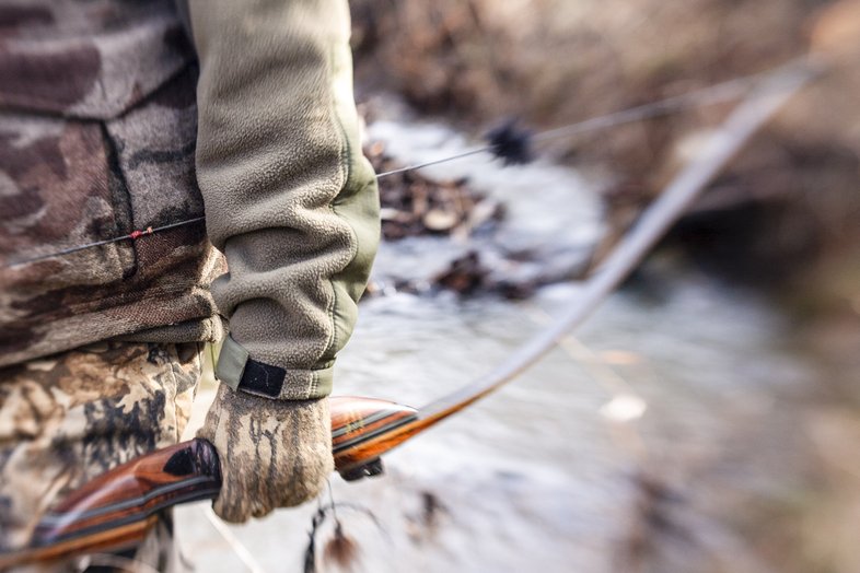 Person holding a traditional bow.