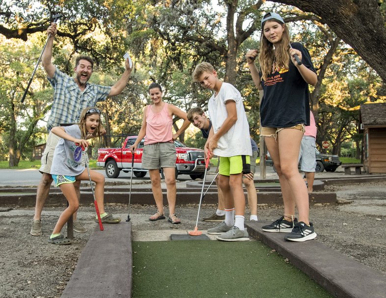 Family playing mini golf at Garner State Park.