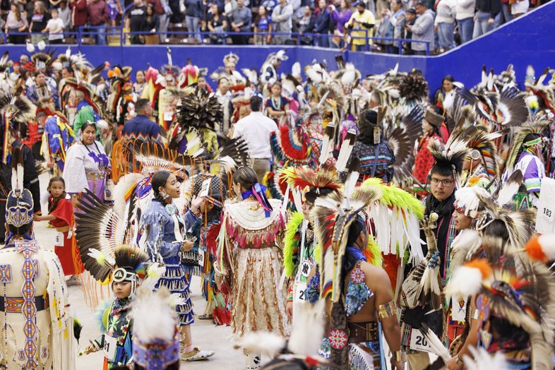 People in Native American attire at the annual Powwow at the Austin Convention Center.