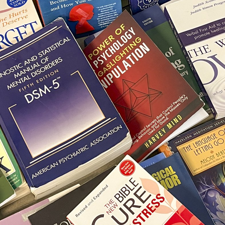 A pile of numerous psychology books with various titles.