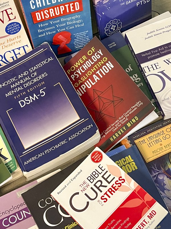 A pile of numerous psychology books with various titles.