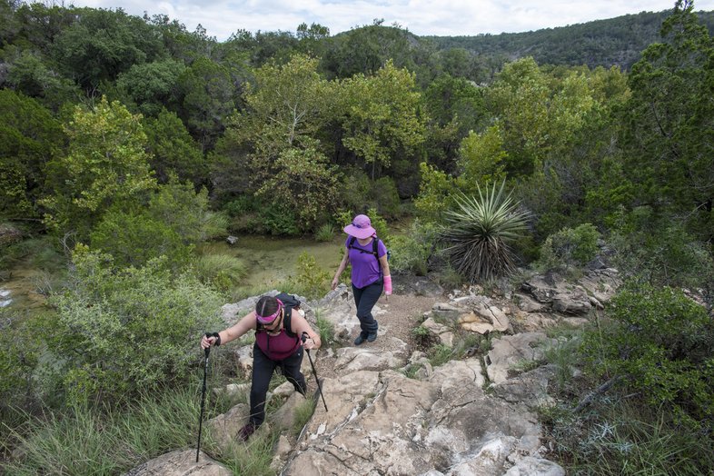 Two women hiking along a trail at Colorado Bend State Park