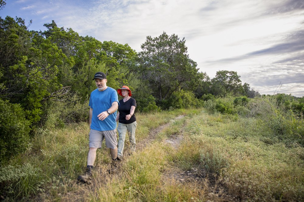 A couple hikes along a trail at Government Canyon State Natural Area