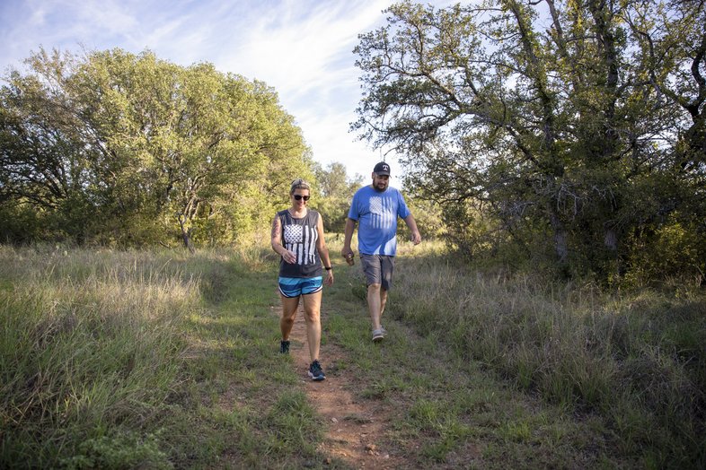 A man and a woman hike along the trail