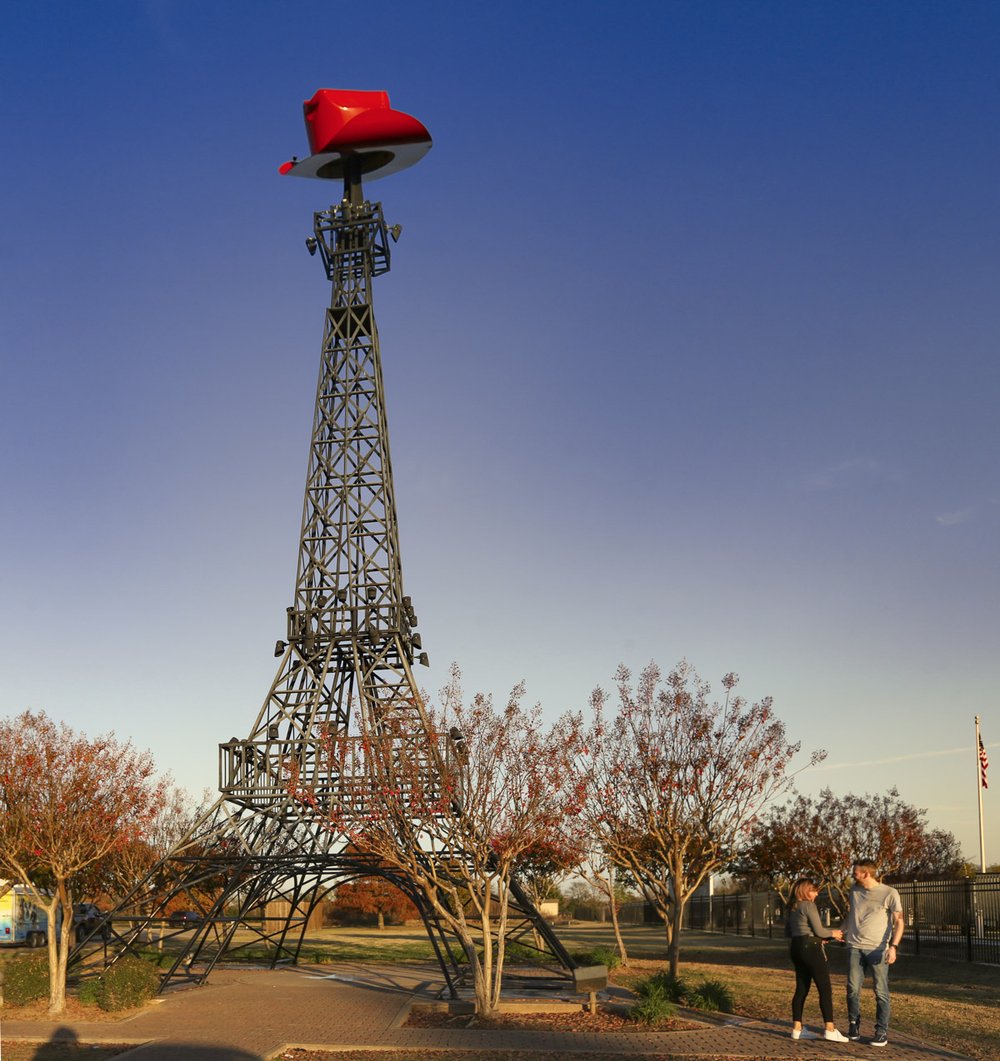 A replica of the Eiffel Tower with a red cowboy hat on top