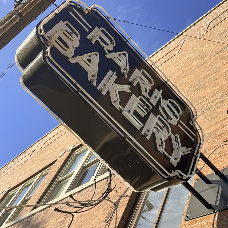 An unlit neon sign for the Paris Bakery
