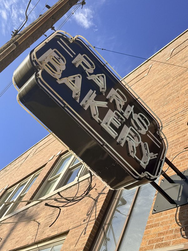 An unlit neon sign for the Paris Bakery