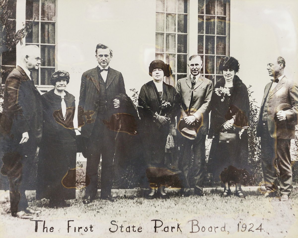 1923 texas state parks board lined up on the grass outside a building