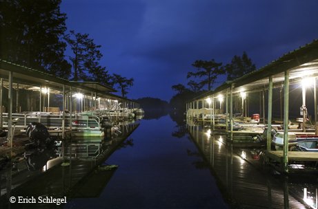 two rows of boat docs lit up at night