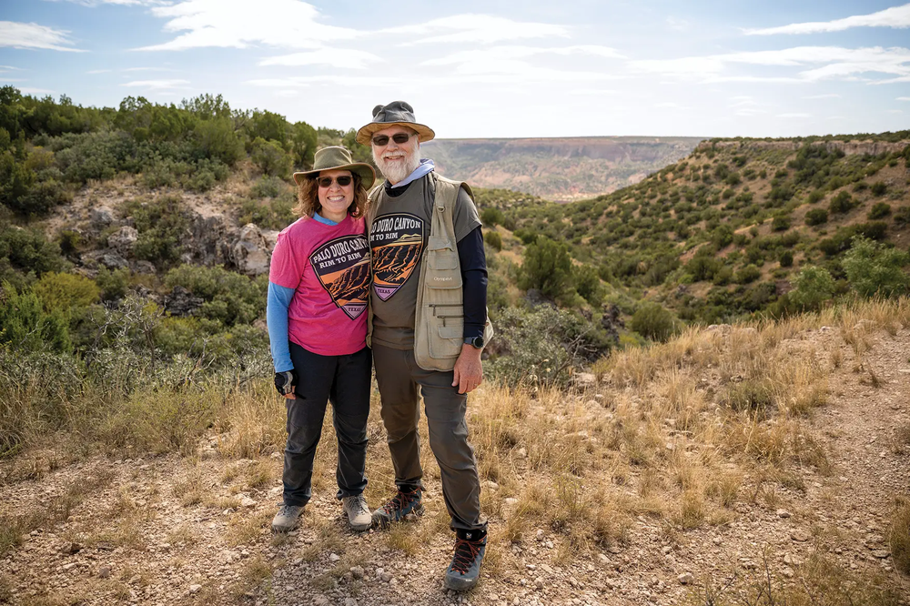 2 hikers standing together on the rim of Palo Duro Canon