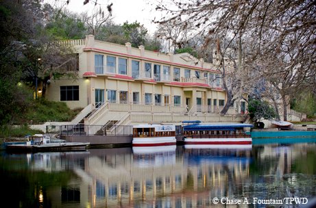 Glass-bottom boats are docked outside Spring Lake Hall