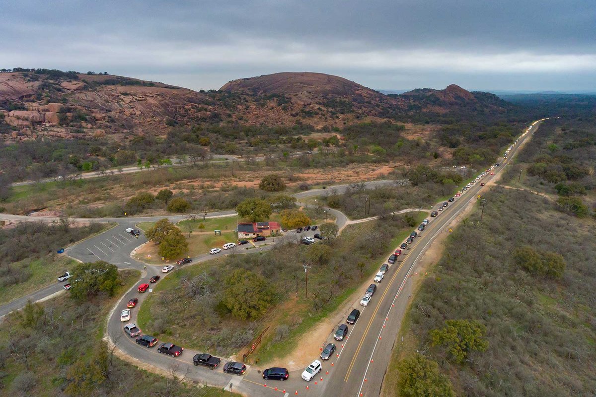 A line of cars trying to enter a park.
