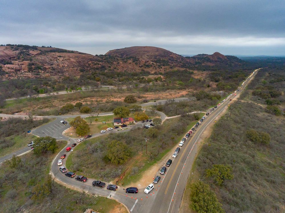A line of cars trying to enter a park.