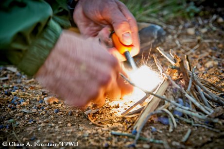 A person starting a fire.