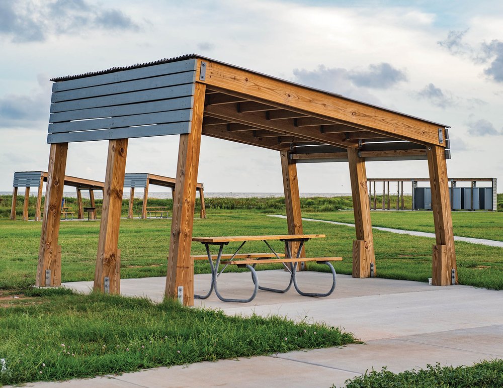 A picnic table with a flat rectangula structre above.