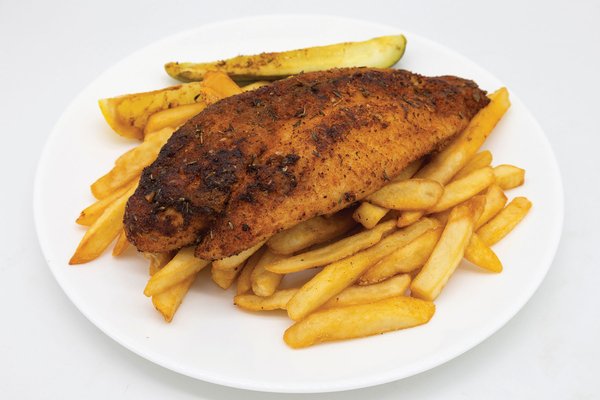 A plate with canjun blackened catfish on top of fries