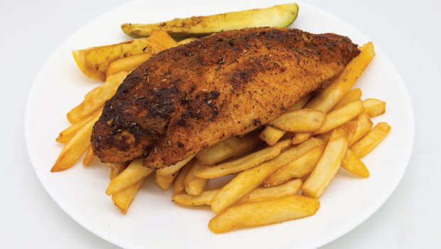 A plate with canjun blackened catfish on top of fries
