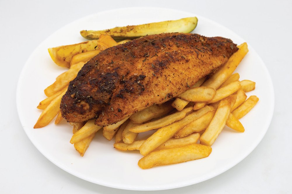 A plate with canjun blackened catfish on top of fries