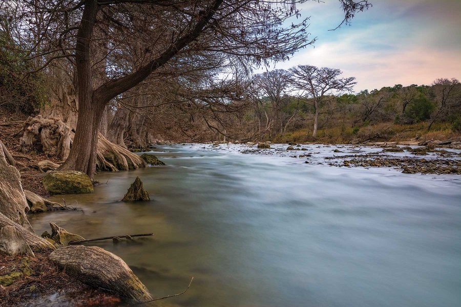 A view of the Guadalupe River rapids from the river bank.