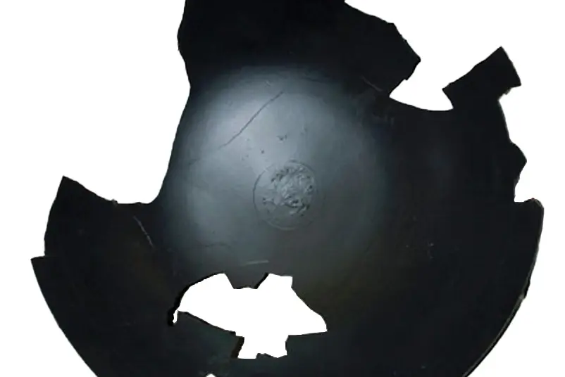 Black pieced together wok artifact with some pieces missing