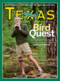 August-September 2013 Cover - Man in the woods walking on rocky terrain with binoculars- Title: Bird Quest