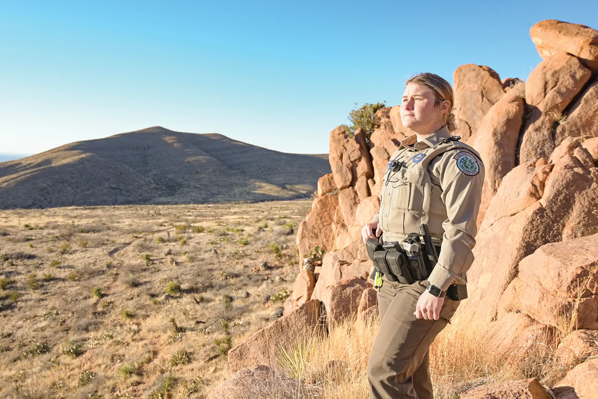 Autumn Gillepsie a park police officer standing in front of a rock formation
