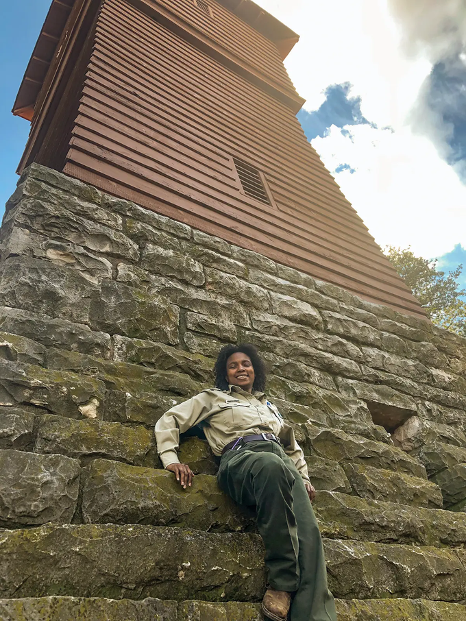 Candyce Johnson leaning against a tower at Abilene State Park