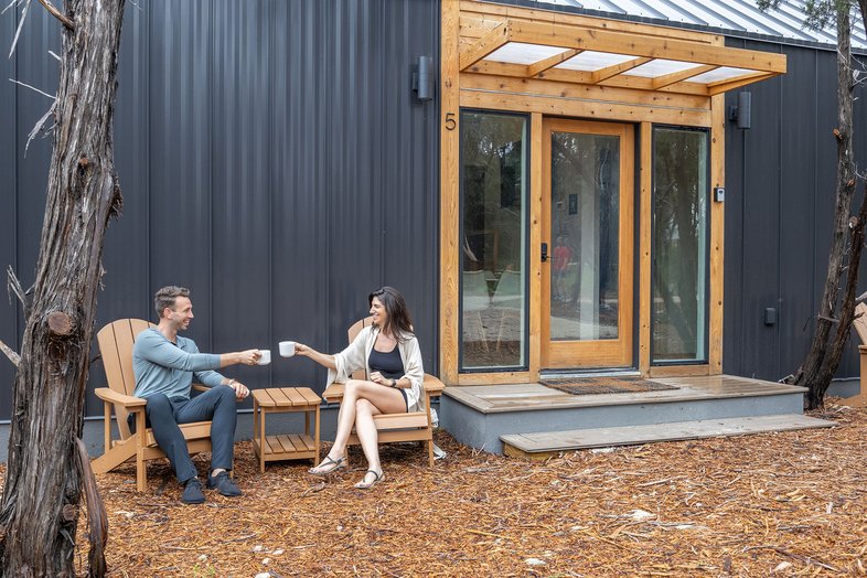 Couple drinking coffee on their private deck at The Cedars Ranch.
