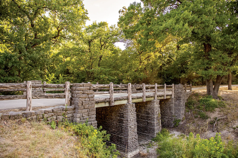 Cleburne hiking trail bridge leading to a wooded area