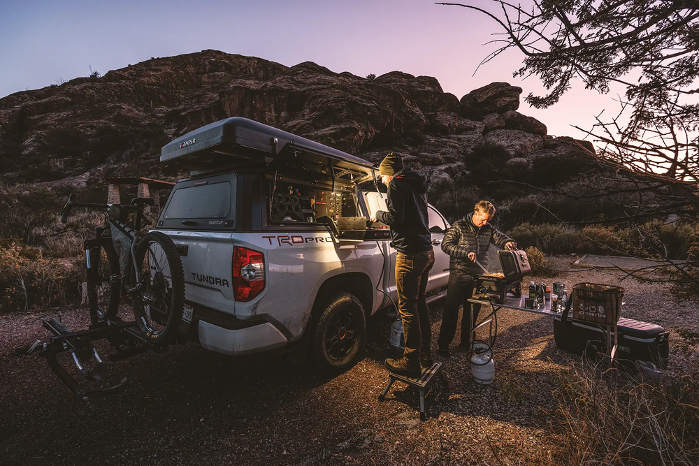 Hueco Tanks at sunrise with two people getting set up to make coffee and breakfast