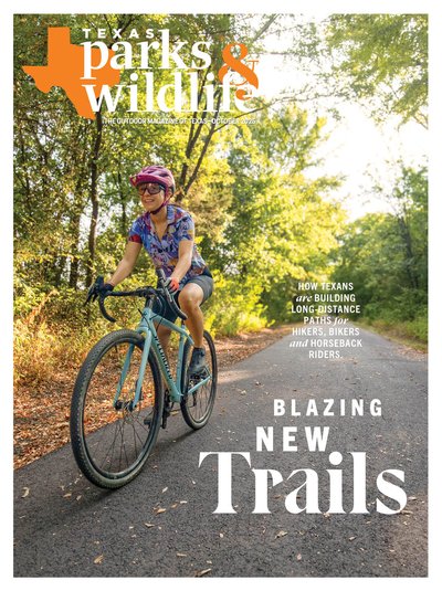 Cover_October 2025 - Woman riding a bike on a paved trail through the trees - Title: Blazing New Trails