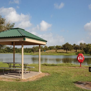 Covered table by the water at Lake Corpus Christi State Park