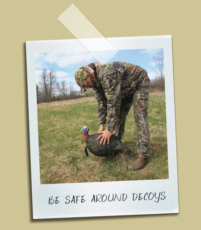 Hunter safely handling a turkey decoy.