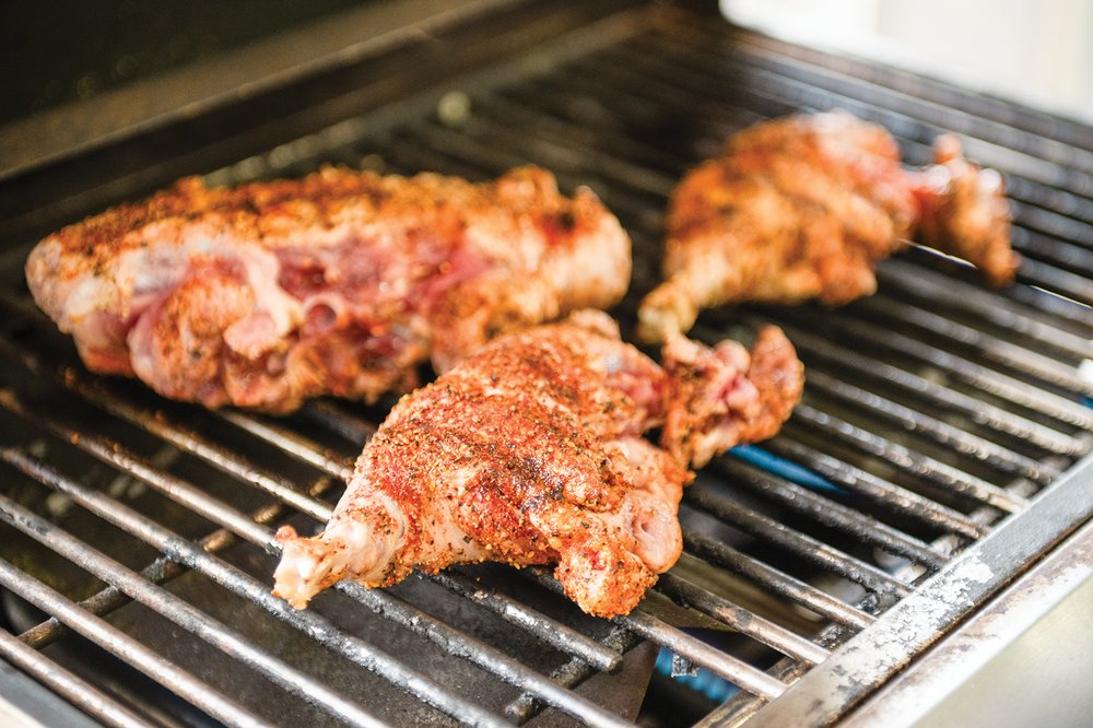 Feral hog being prepared in a smoker.