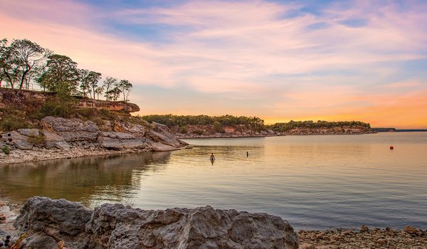 View of sunset, water and cliff faces.