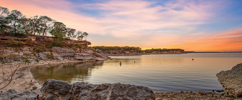 View of sunset, water and cliff faces.