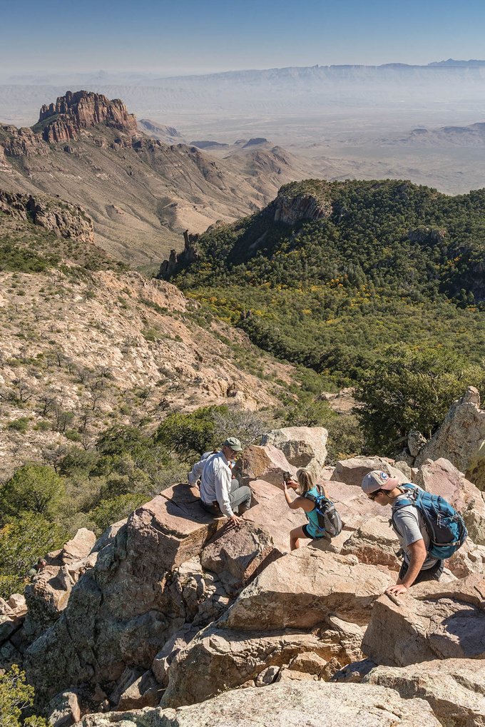 Family climbing a rocky peak at Big Bend National Park.