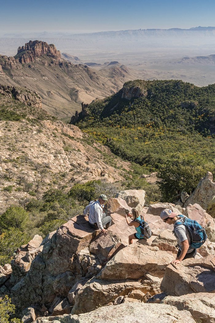 Family climbing a rocky peak at Big Bend National Park.