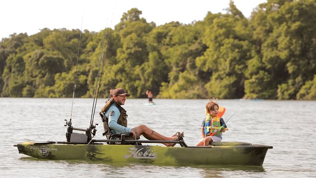 Father and son fishing from a canoe.