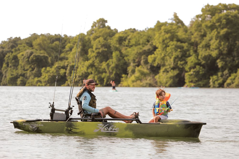 Father and son fishing from a canoe.