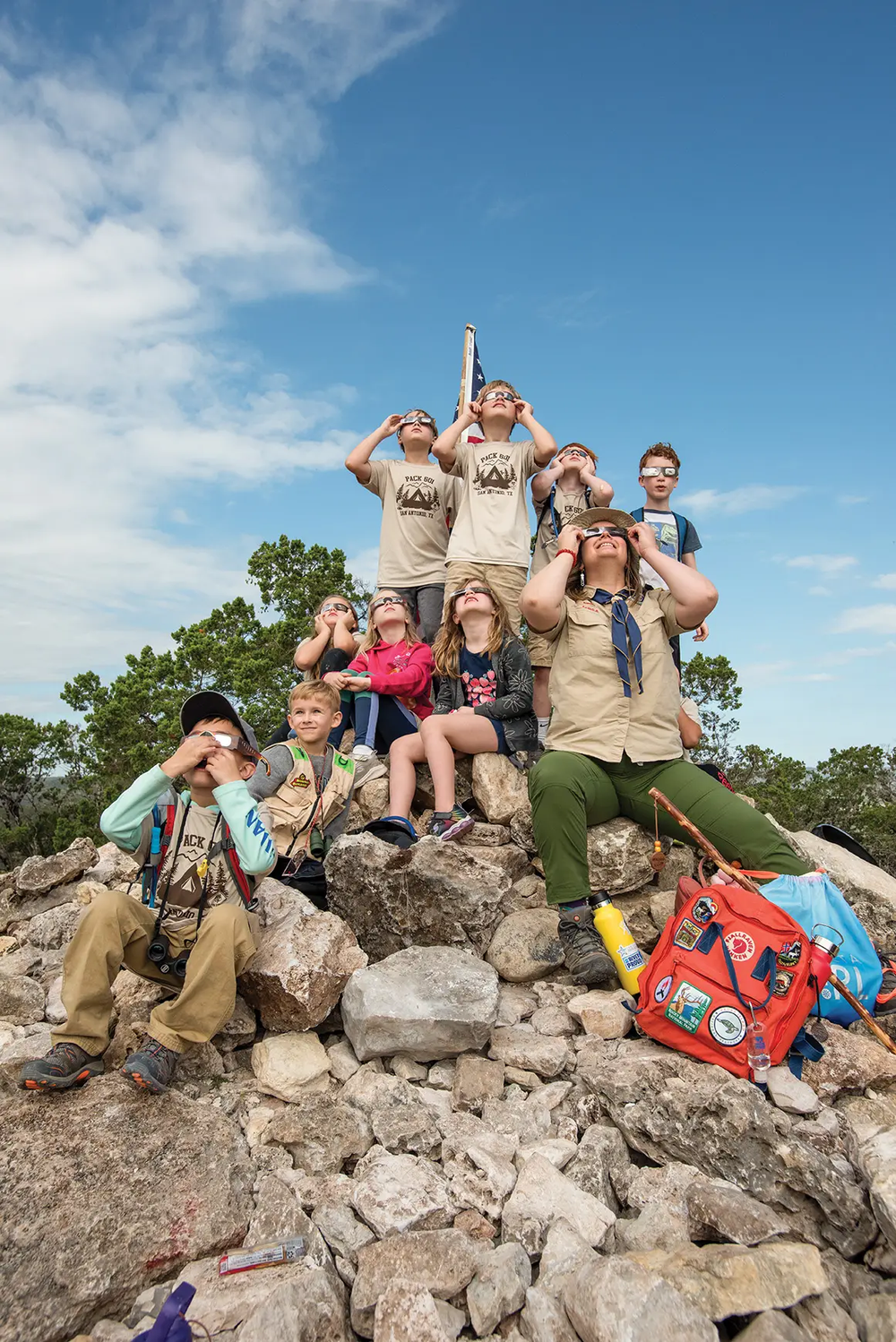 Guide and children wear solar glasses to view the solar eclipse