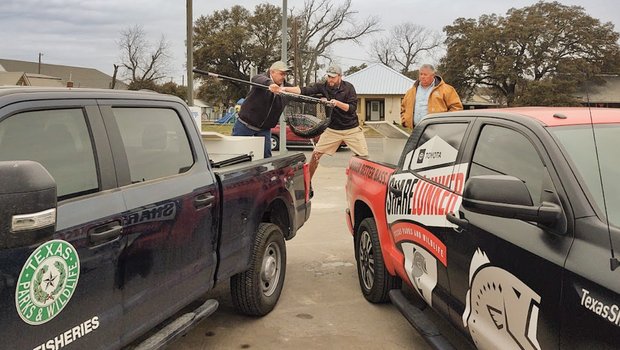 Handoff of Ivie Lunker from Distirct truck to lunker truck for faster transport to Athens